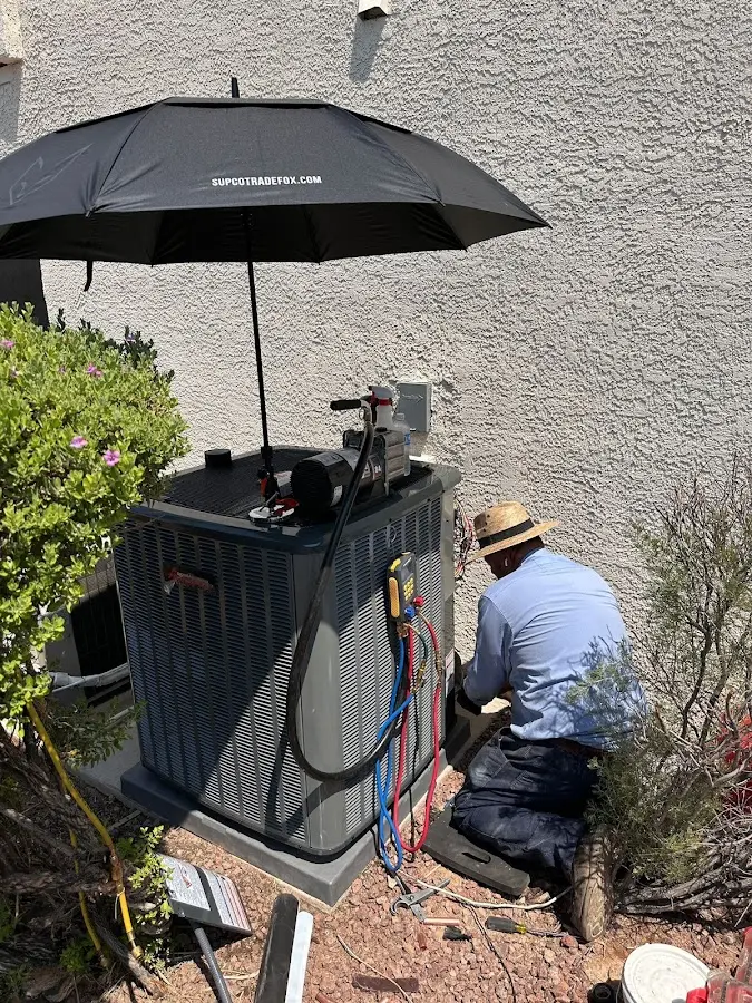 HVAC technician performing outdoor AC maintenance in West Valley City